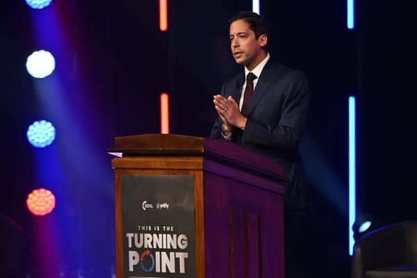 A person talks at a podium