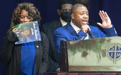 A man speaks on a podium.