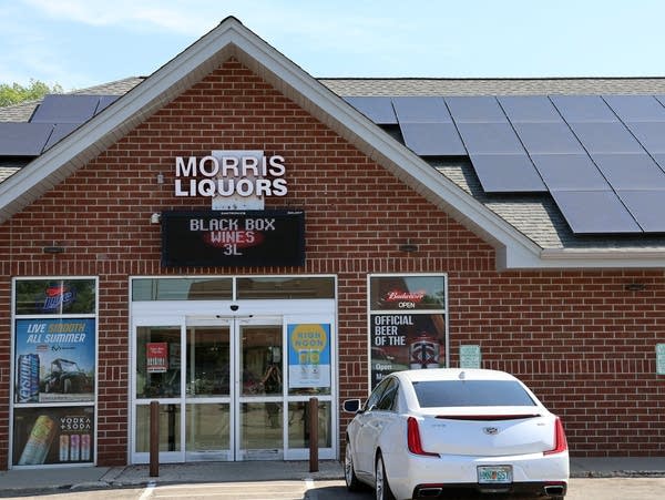 a brick building with solar panels on the roof