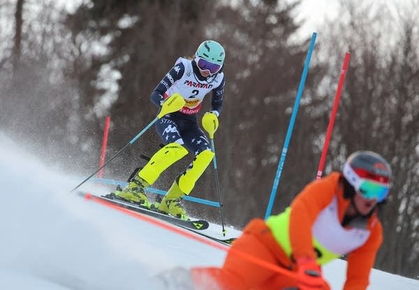 An athlete skis down a hill.