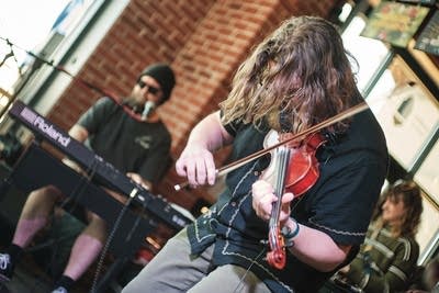 Two musicians performing in a taproom