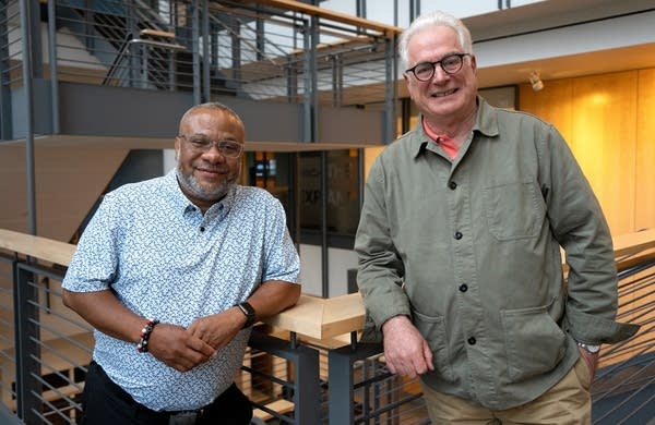 two men pose for a portrait