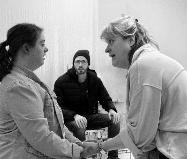 A black and white photo of three actors performing