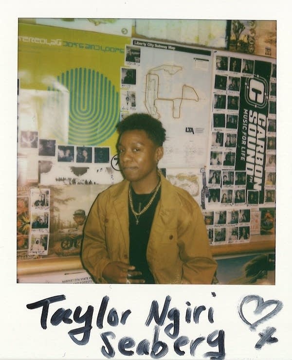 Taylor Ngiri Seaberg posing for a polaroid photo