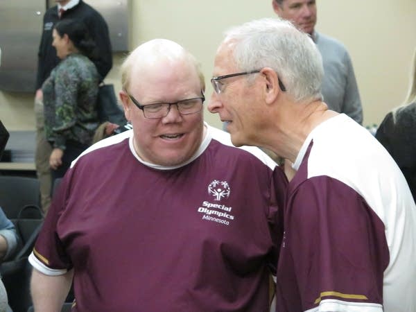 Two men speak at an event