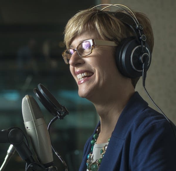 A woman in front of a microphone