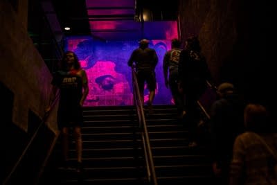 People walking up and down a dark stairwell 