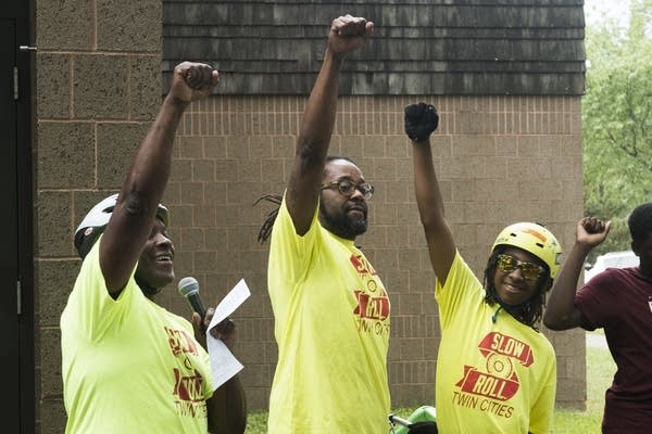 Slow Roll leaders throw their fists in the air.