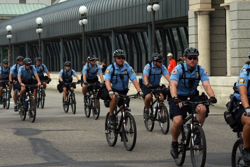 Bicycle cops ride down Cedar St.