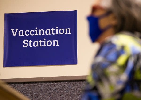 A woman waits for her vaccine. 