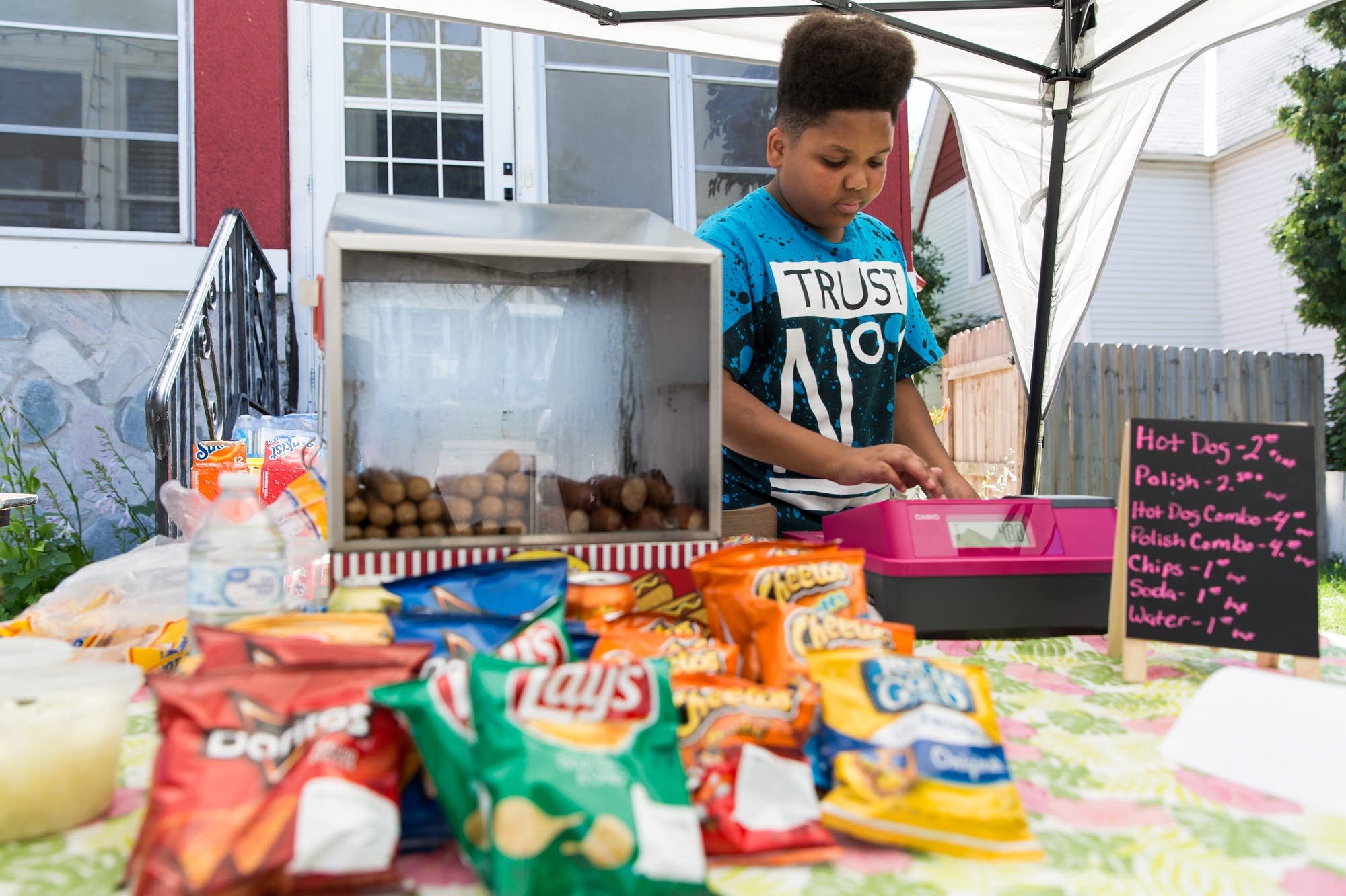 Jaequan Faulkner rings up an order at Jaequan's Old Fashioned Hot Dogs.