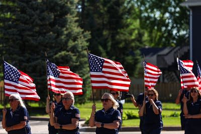 A ceremonial color guard holds American flags