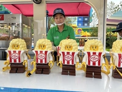 A staffer at Legoland Shanghai stands behind a popcorn stand