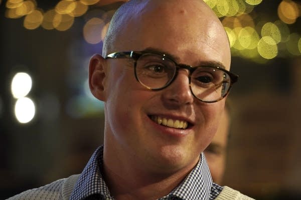 A person smiles at the afterparty