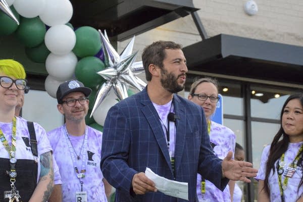 man speaks at ribbon cutting ceremony