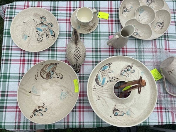 Aerial shot of several handmade bowls, plates and vases sitting on a table.
