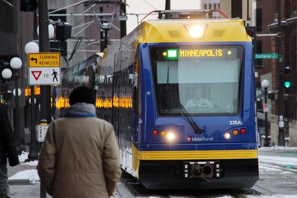 A train pulls up at the Cedar Ave. station.