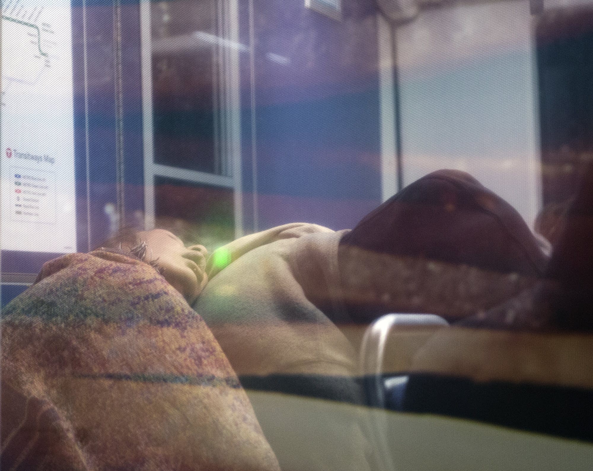 Many riders are fast asleep as they ride the train at 2:00 a.m.