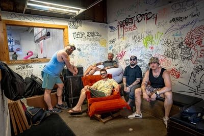 5 men pose for a photo