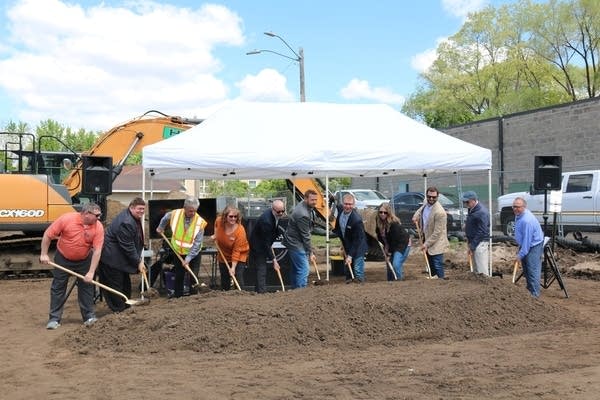 people shovel dirt