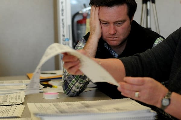 A Coleman representative watches the recount