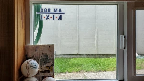 Photo of Andrew's basement window w/ a KIXI radio window cling