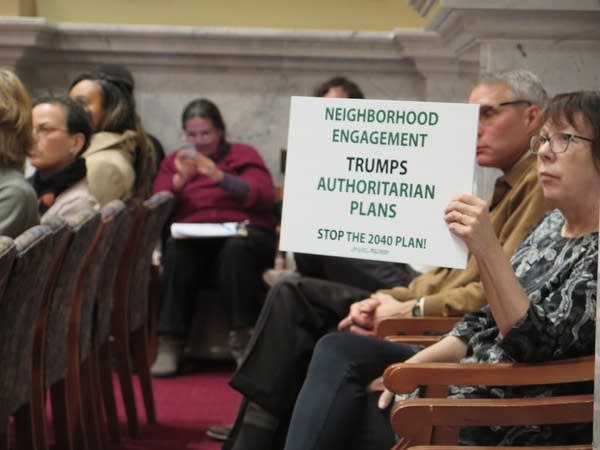 An audience member holds up a sign.