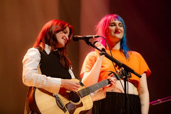 Two people smiling on stage