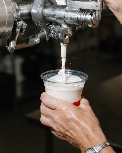 Milk is poured from a machine