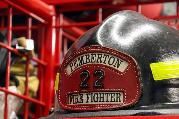 A firefighter's helmet sits in a locker.