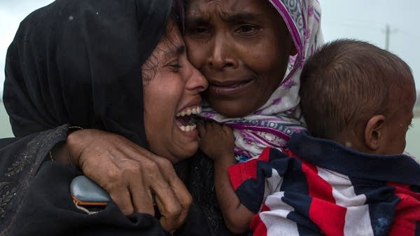 Rohingya refugees embrace one another, finally reunited