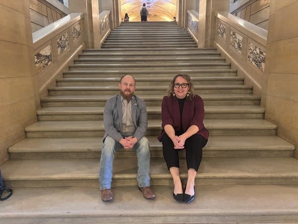 Two lawmakers posing for photo inside of state capitol
