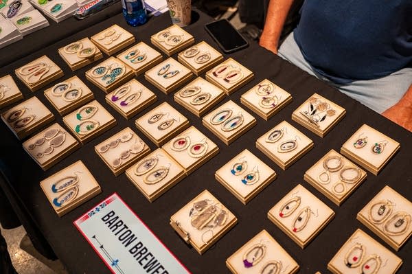 A table shows a selection of handmade earrings.