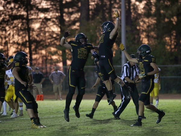 Paradise running back Lucas Hartley (center right)