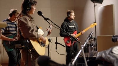 A band performing in a recording studio